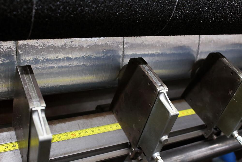 Black Anti-Slip Material being Cut on a Crush Cutter into Rolls of Wide Non Slip Tape 2